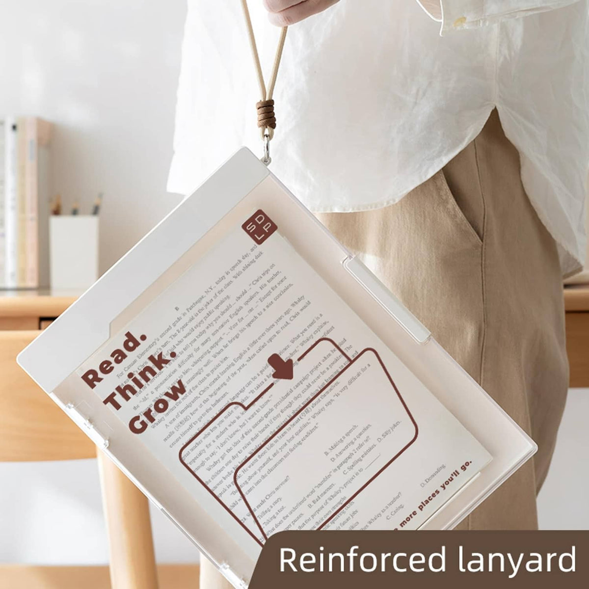 White clipboard with inner plastic folder and brown lanyard strap held by hand