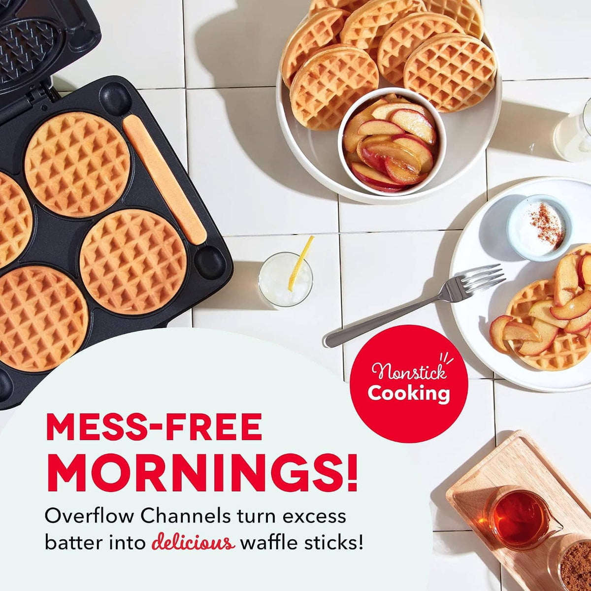 Mini waffle maker with open lid showing four waffles, plus breakfast food items