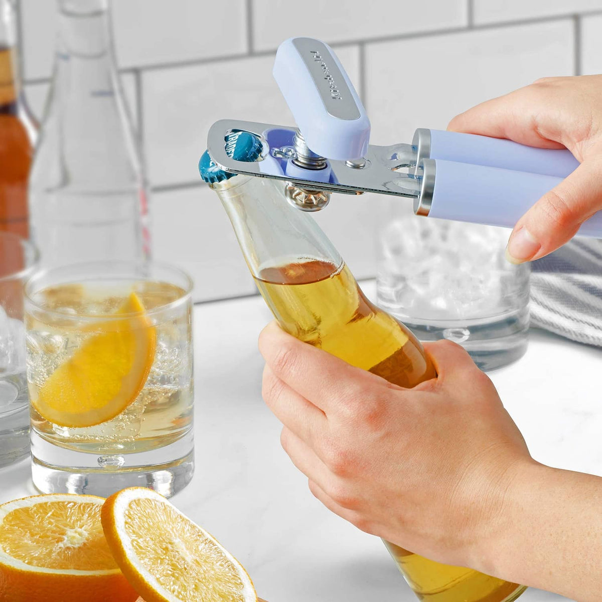 Lavender bottle-and-can opener cutting a drink container into a glass.