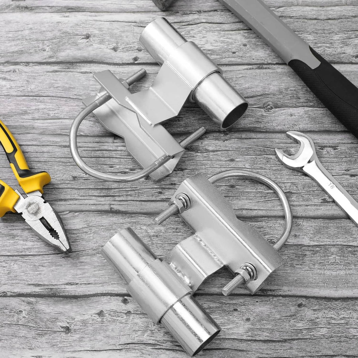 Metal rolling gate roller bracket components with bolts, nuts, and tube rollers