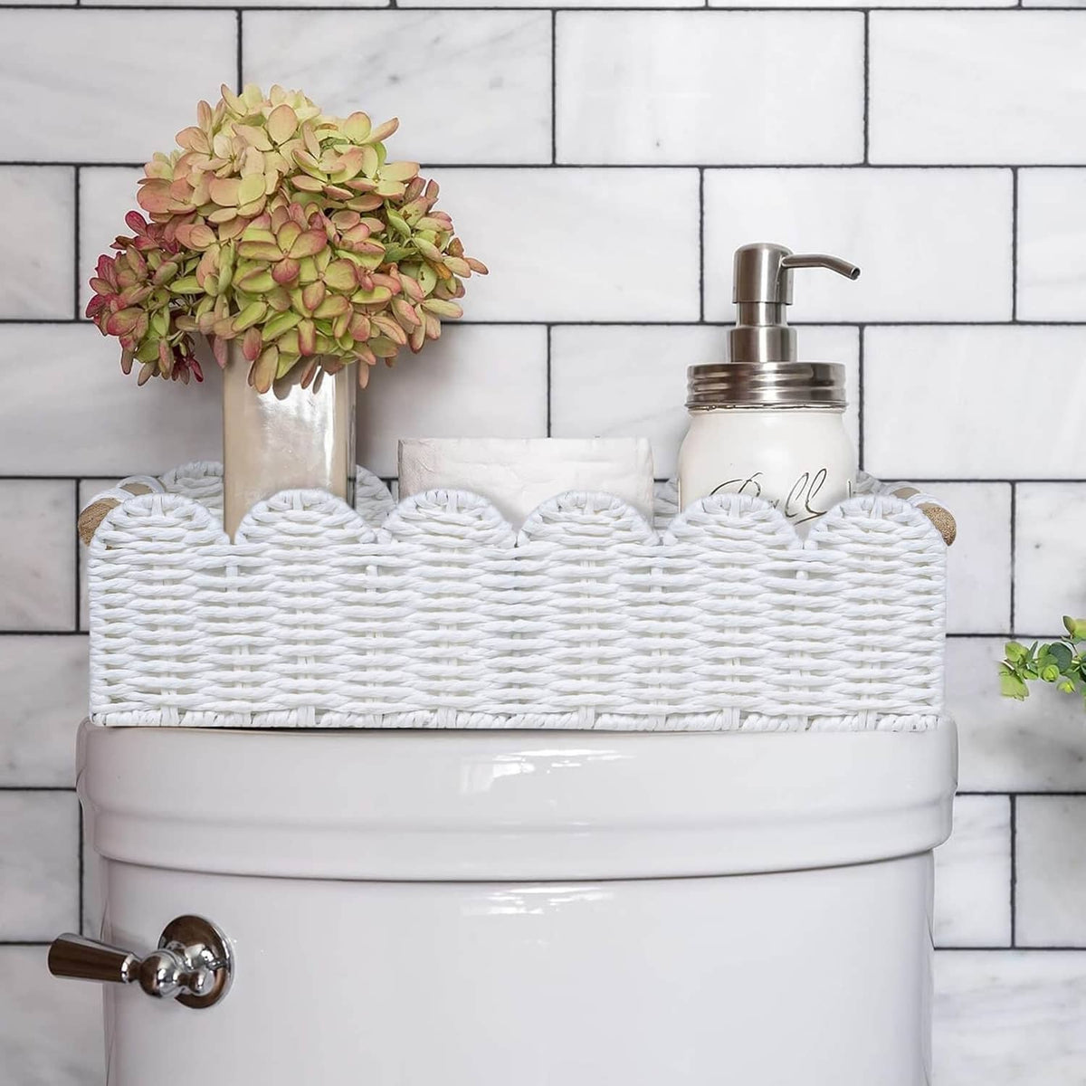 White wicker toilet paper storage basket holding toilet paper rolls