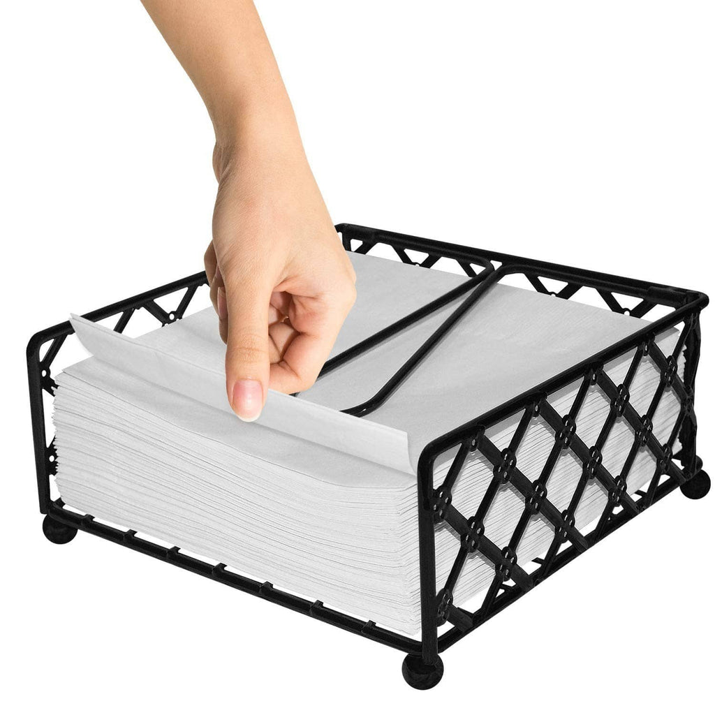 Black lattice napkin holder with stacked white napkins; hand placing a napkin.