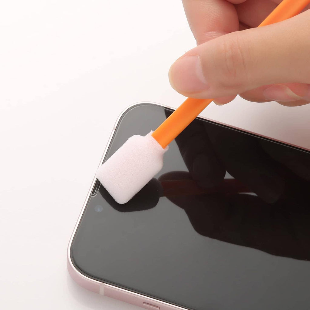 Orange foam cleaning swab with white tip wiping a smartphone screen.