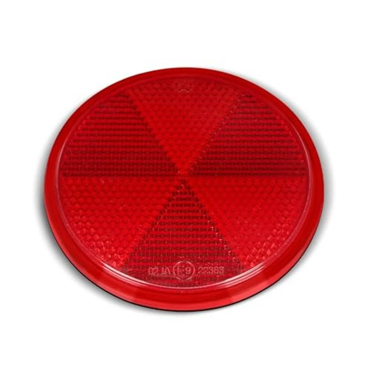 Close-up of red round reflector with textured star-pattern lens