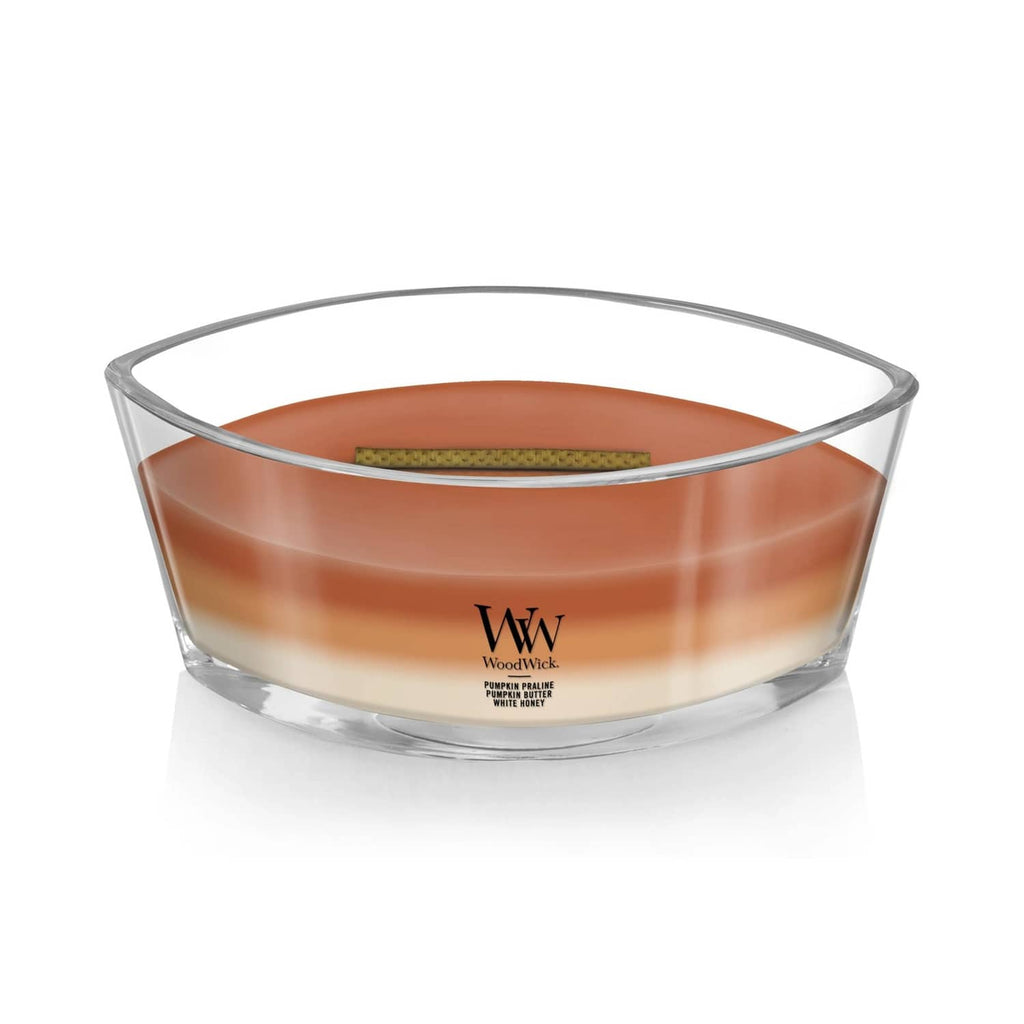 Glass jar candle with amber-orange wax, centered label and visible wooden wick
