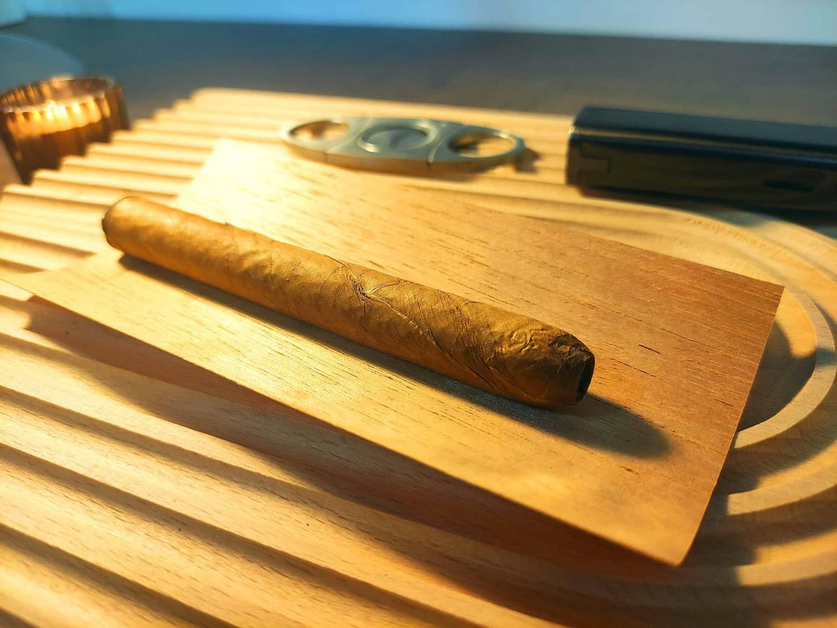 Spanish cedar humidor veneer sheet with one cigar resting on the wood