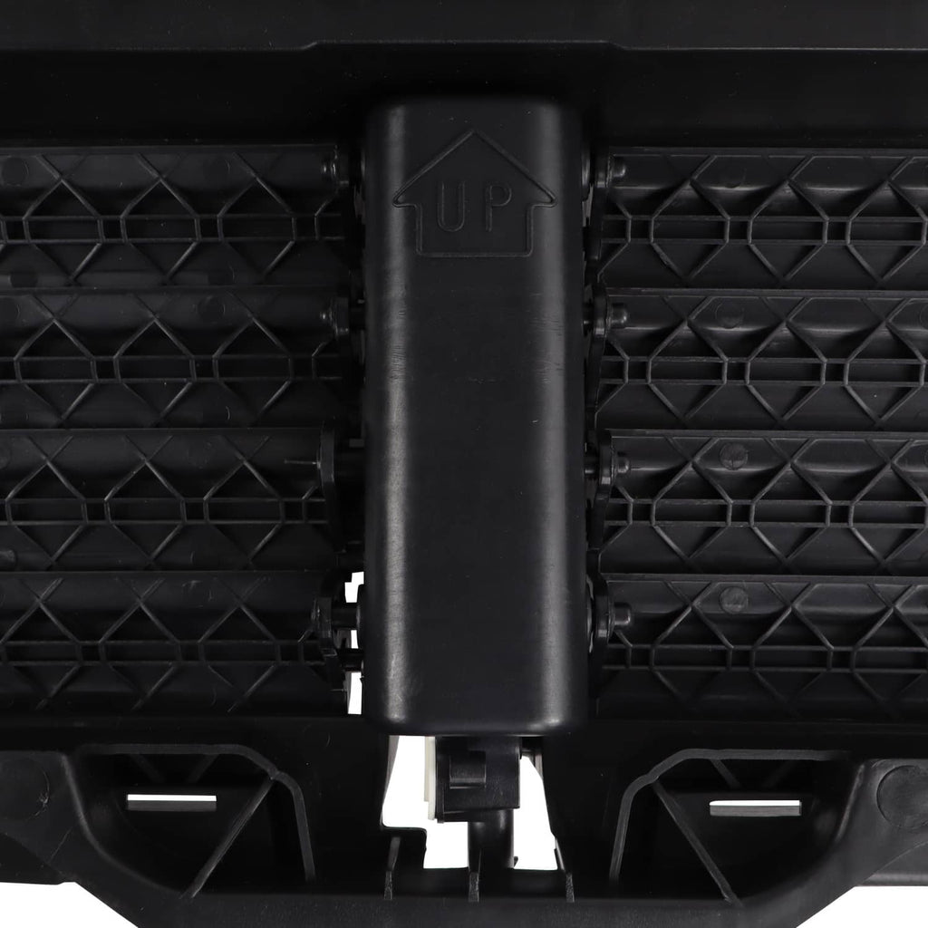Close-up: black upper radiator grille air shutter actuator housing on slat grille