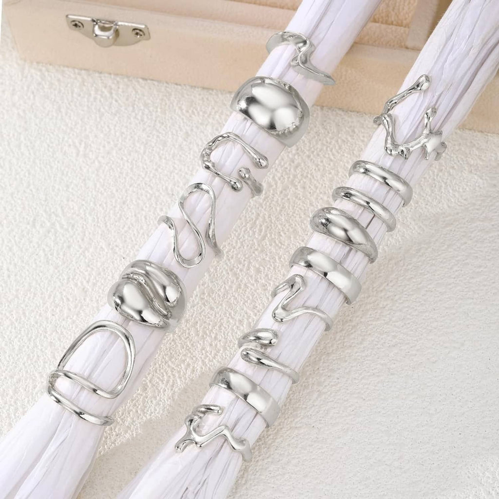Silver ring charm set with white cords and bell-like metal pieces on pouch