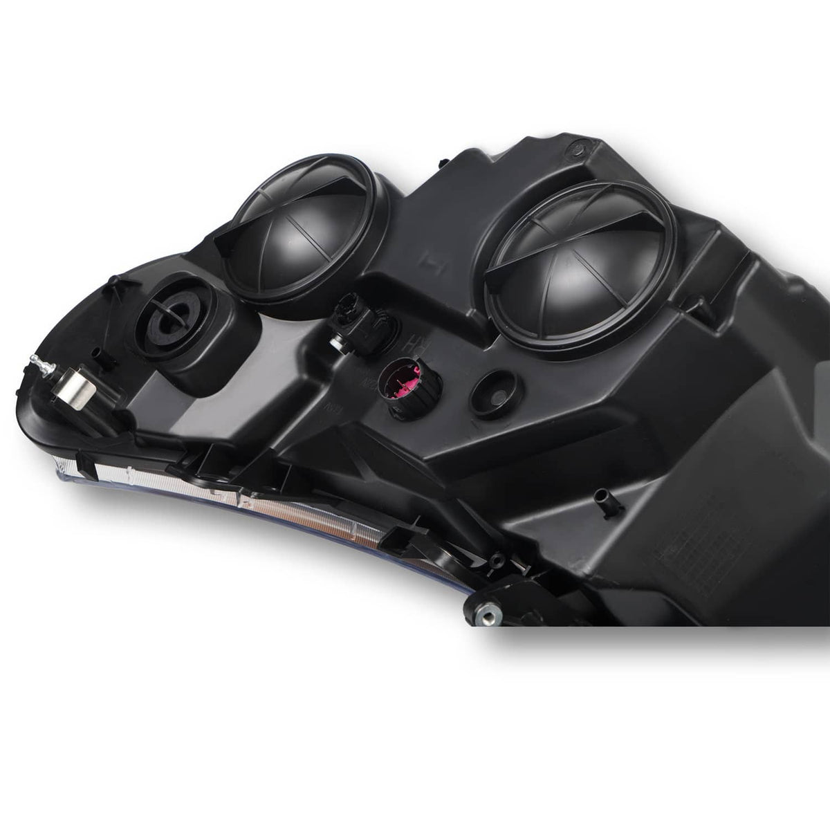 Black headlight assembly showing dual round projectors and wiring connector
