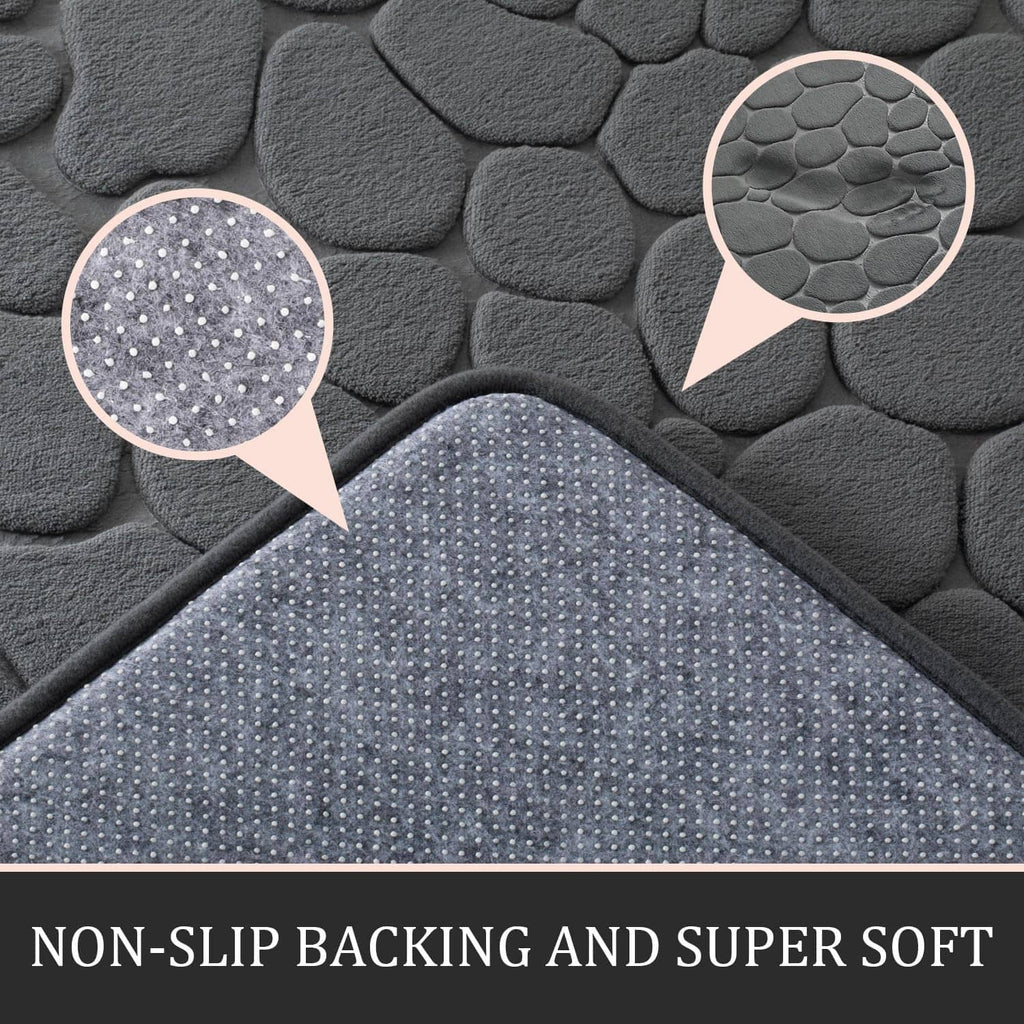 Dark grey bath rug mat with pebble texture surface detail and circular grip pattern