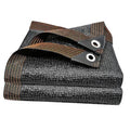 Folded dark shade cloth with bronze stripes and two metal grommets