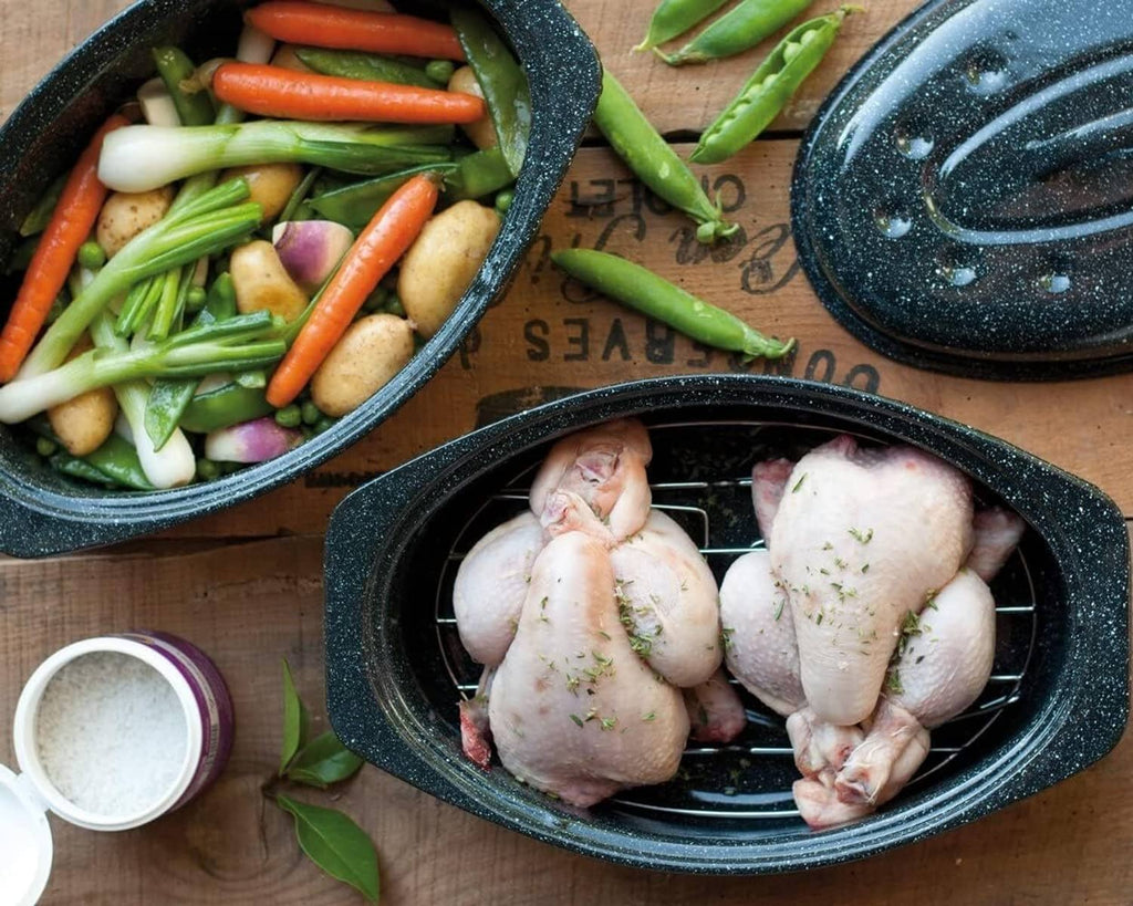 Oval black speckled grill roasting pan with lid, showing vegetables and raw chicken on racks