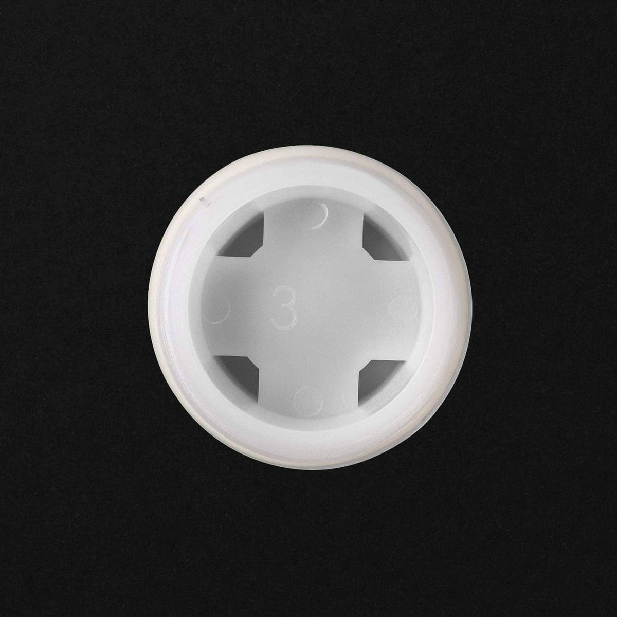 White plastic bung cap underside with circular rim and star drive recess
