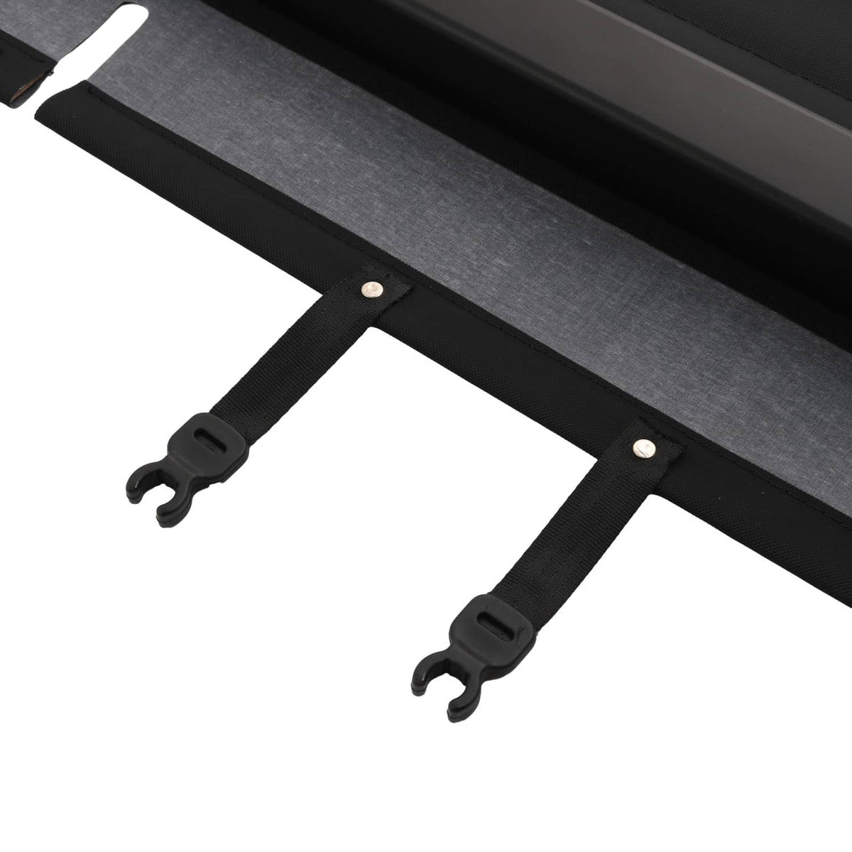 Close-up of black cargo cover straps and mounting clips on the long base bar
