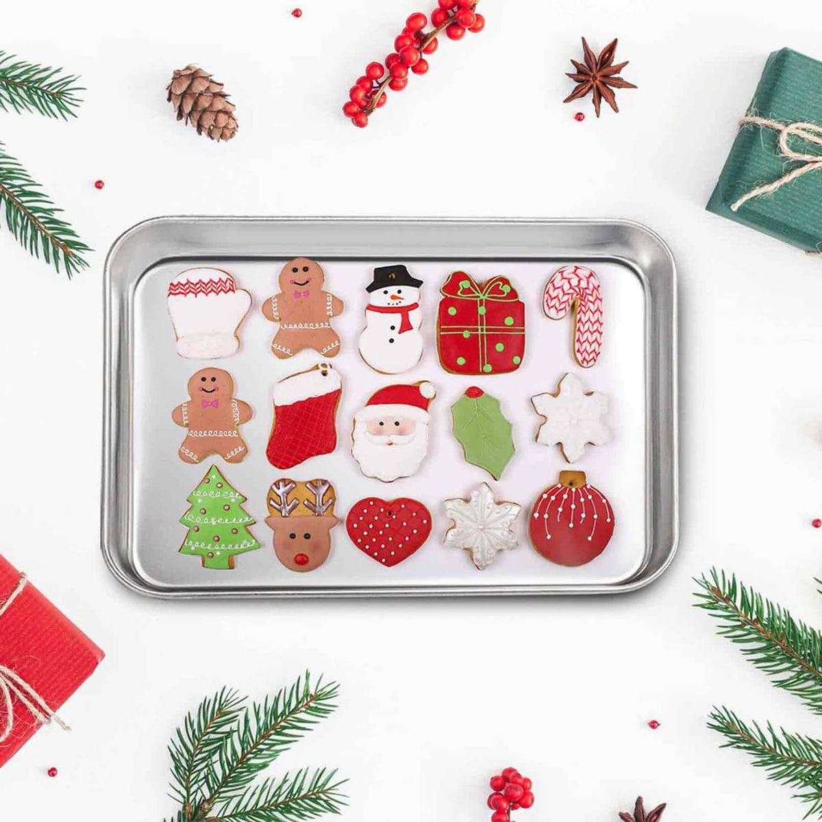 Rectangular stainless steel oven tray with assorted holiday cookies, shallow baking pan