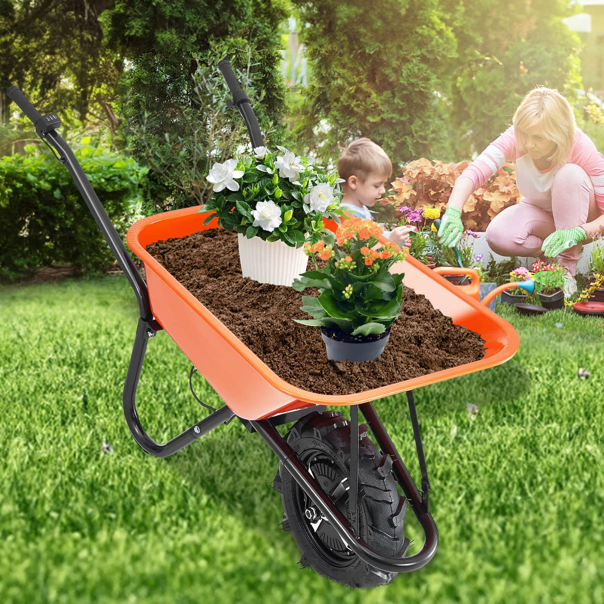 Orange electric one-wheel wheelbarrow cart loaded with potted plants on grass