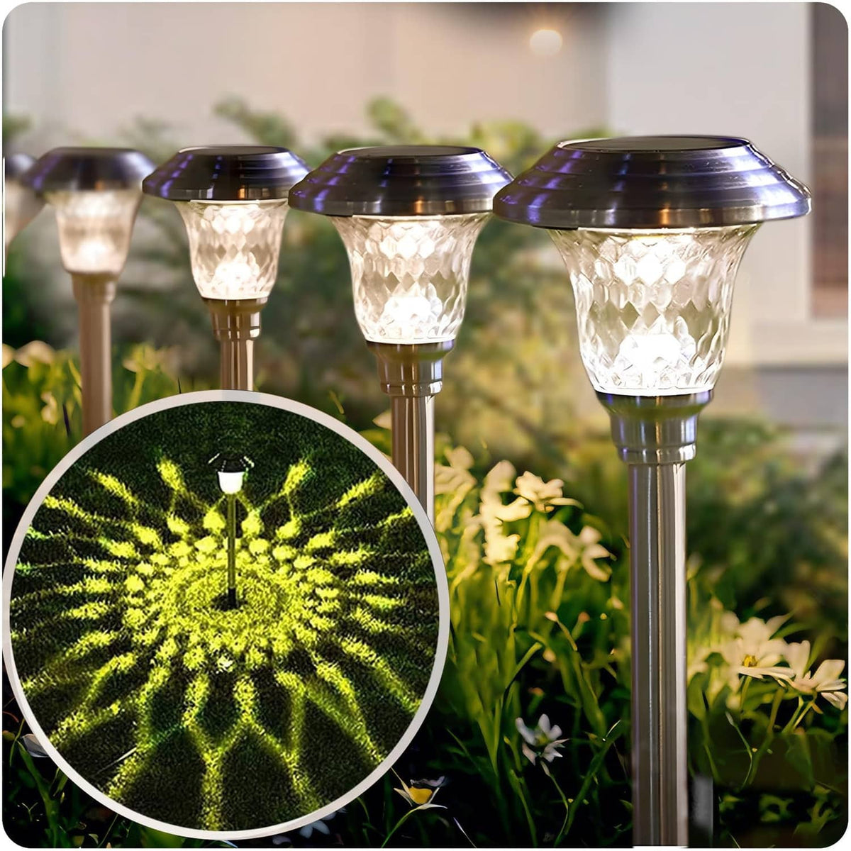 Solar pathway light set with stainless-steel stakes and frosted glass caps, glowing warm white.