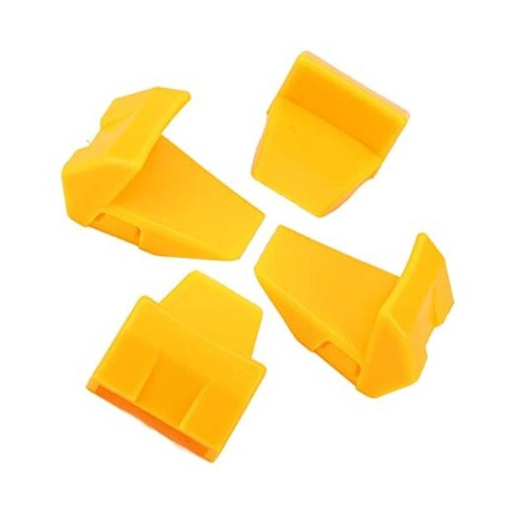 Set of 4 yellow tire changer jaw clamp protector inserts, molded plastic pieces.