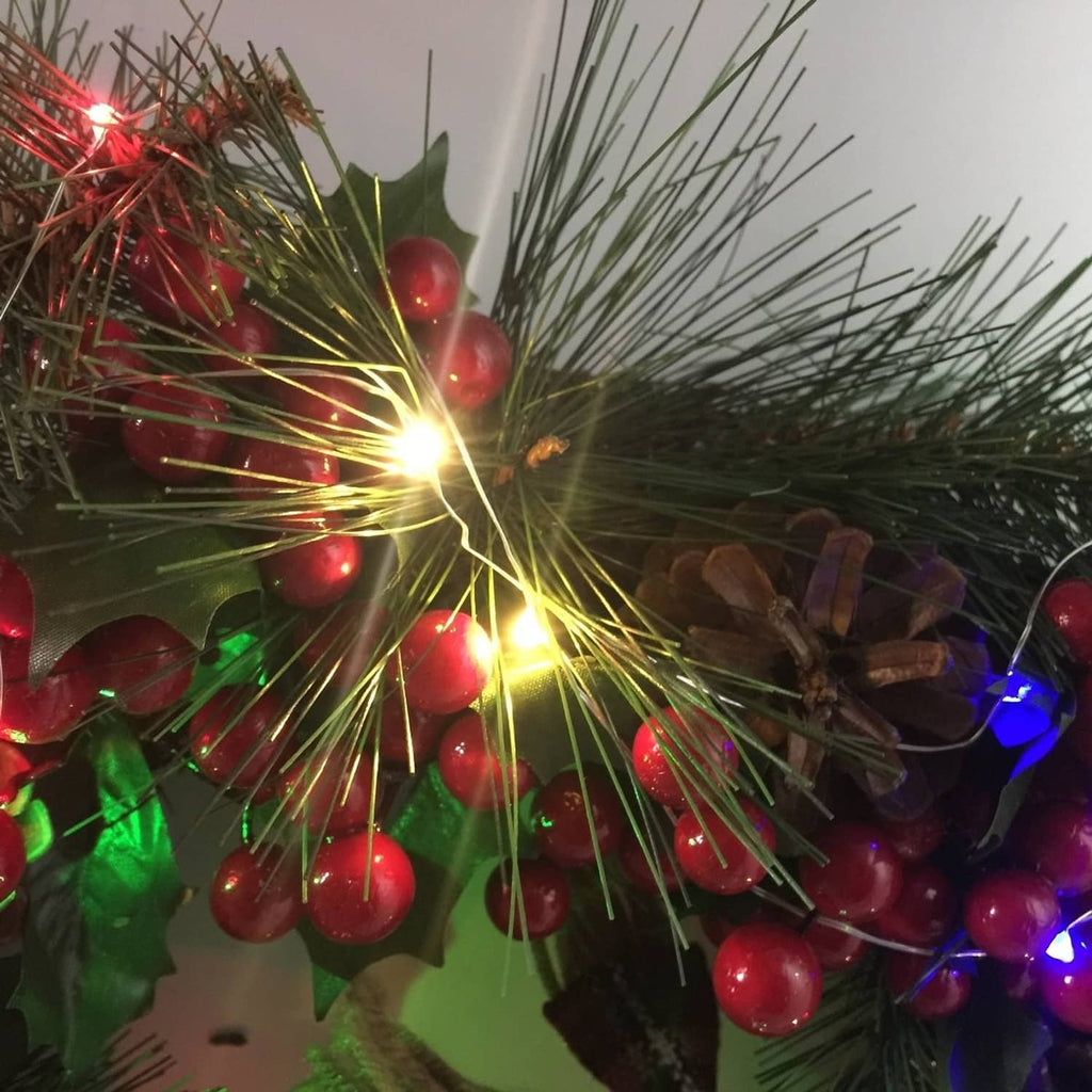 Colorful mini starry string lights wrapped around pine branches