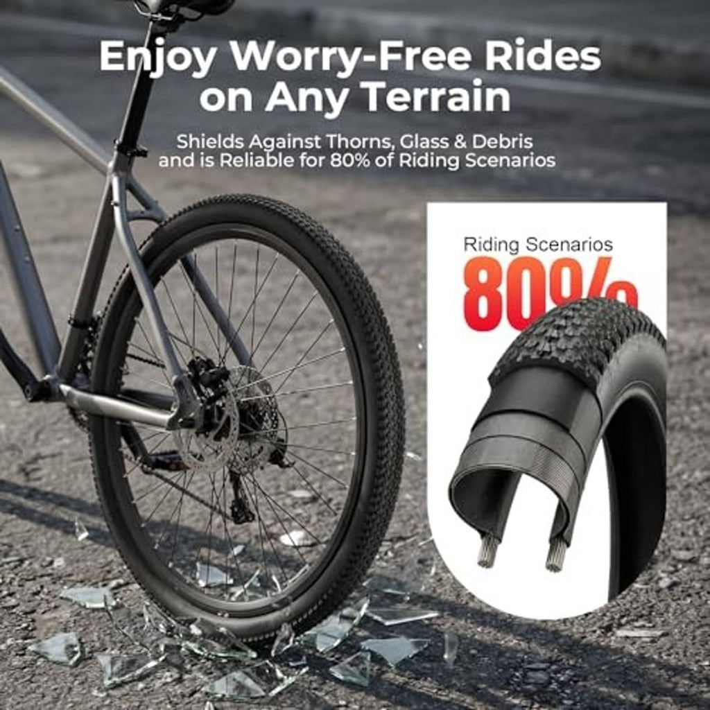 Front bike wheel with thick knobby black tire tread plus spare tire shown