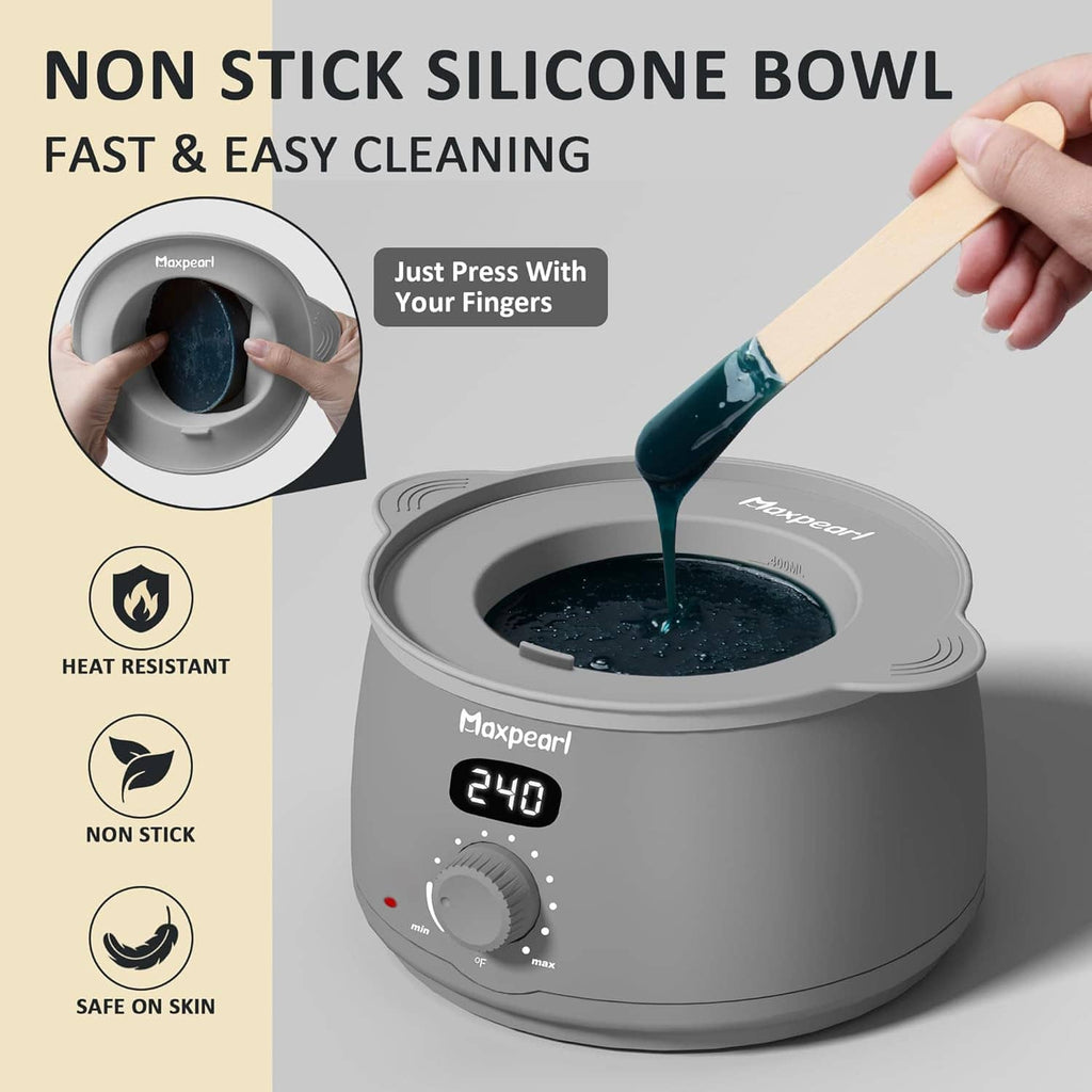Non-stick silicone bowl waxing warmer with blue wax being poured from a spatula
