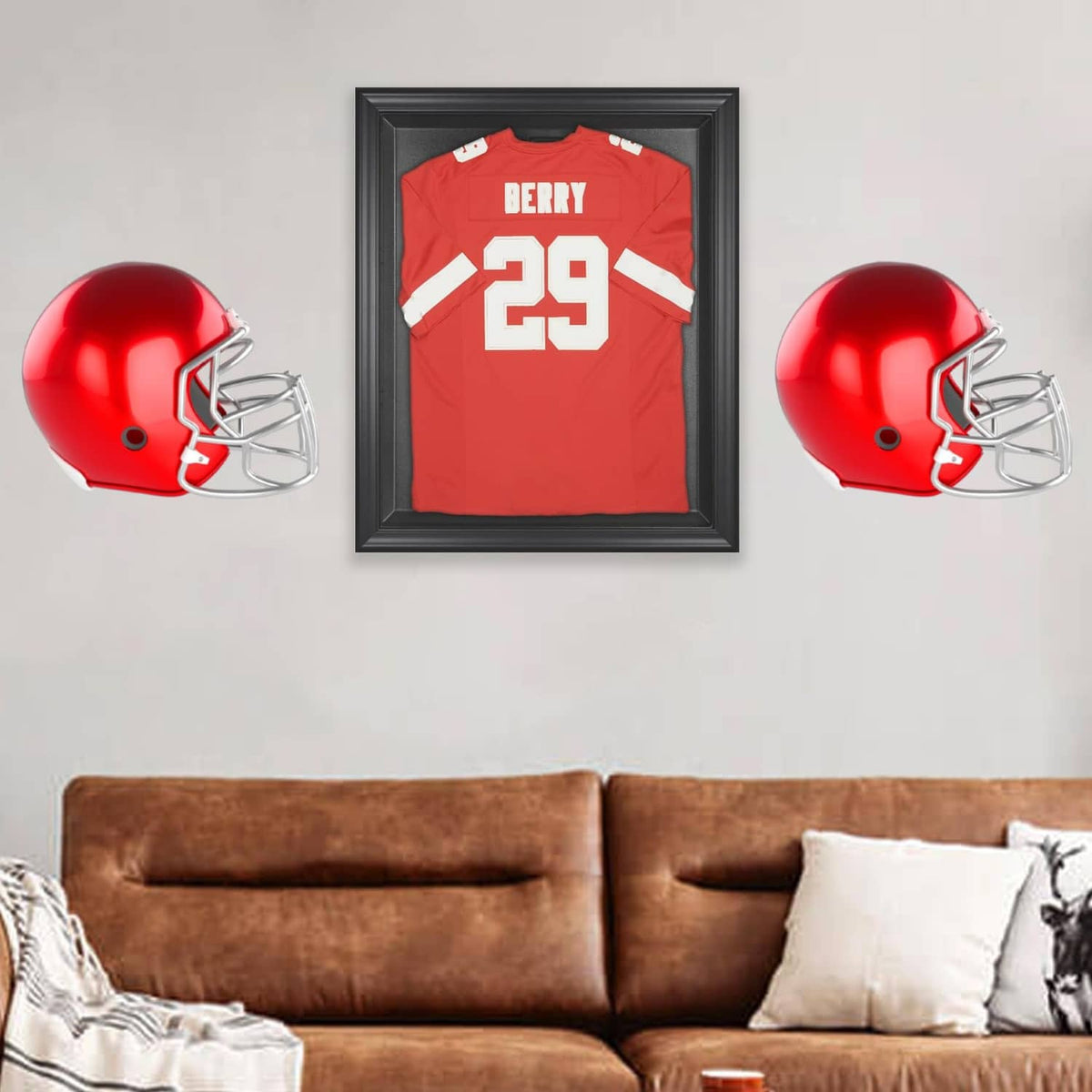 Red football helmet mounted on a black wall display hanger with metal face guard
