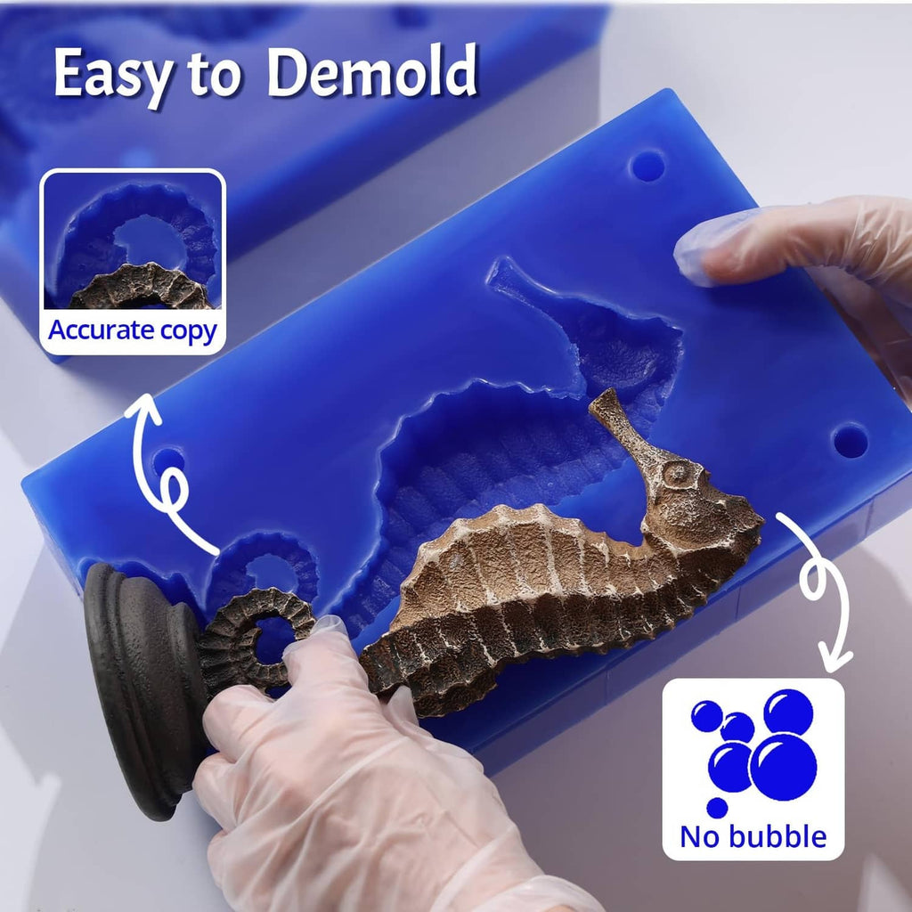 Blue silicone mold with floral relief cavity, held by gloved hands