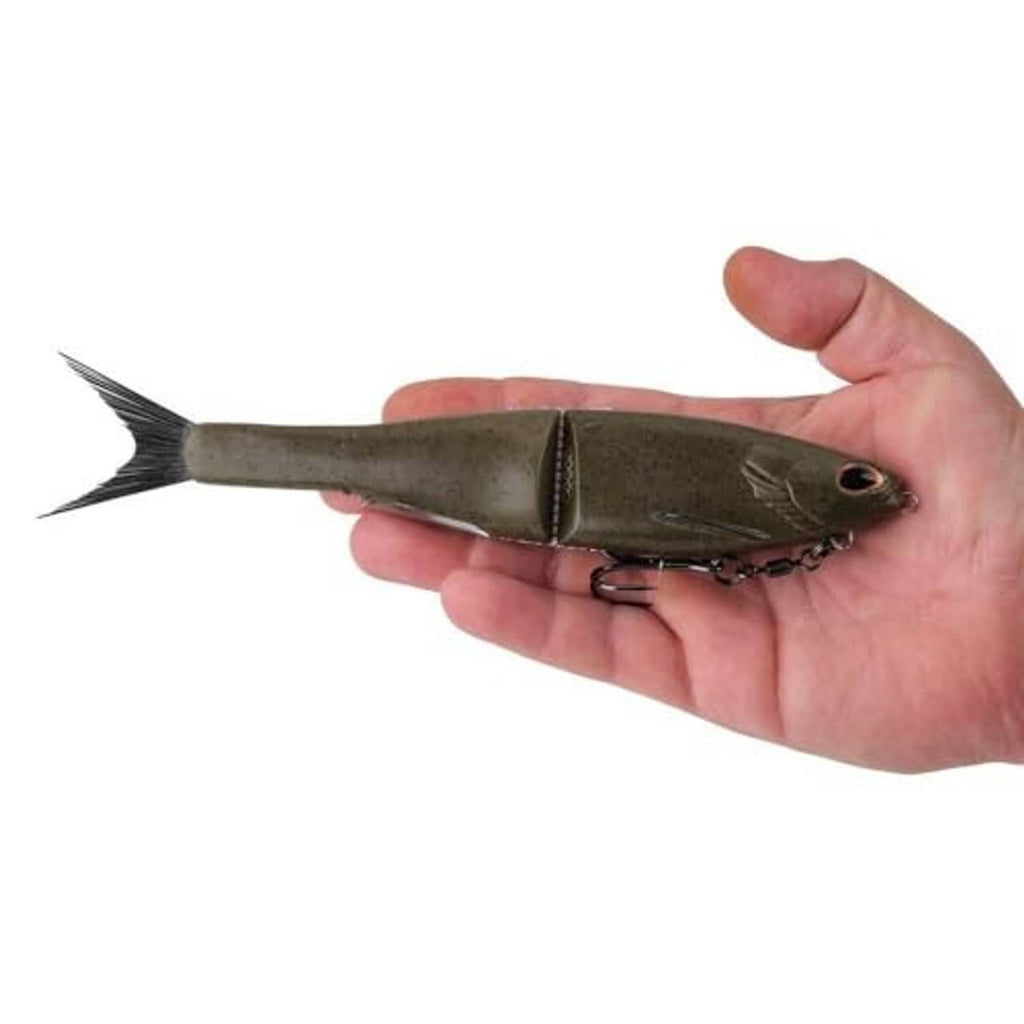 Berkley PowerBait Nessie glide bait held in hand, green pumpkin finish