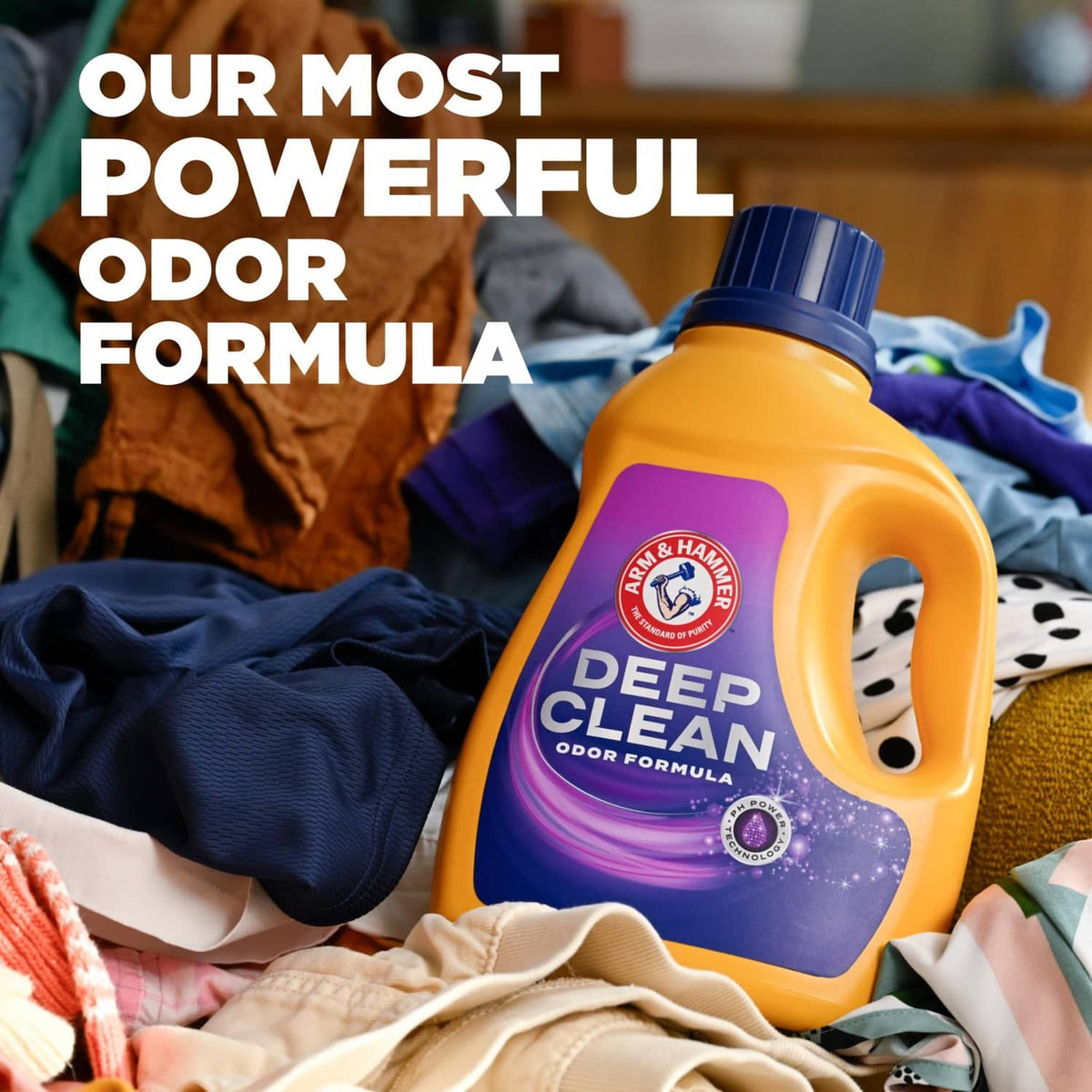 Deep Clean odor formula laundry detergent bottle next to folded clothes.