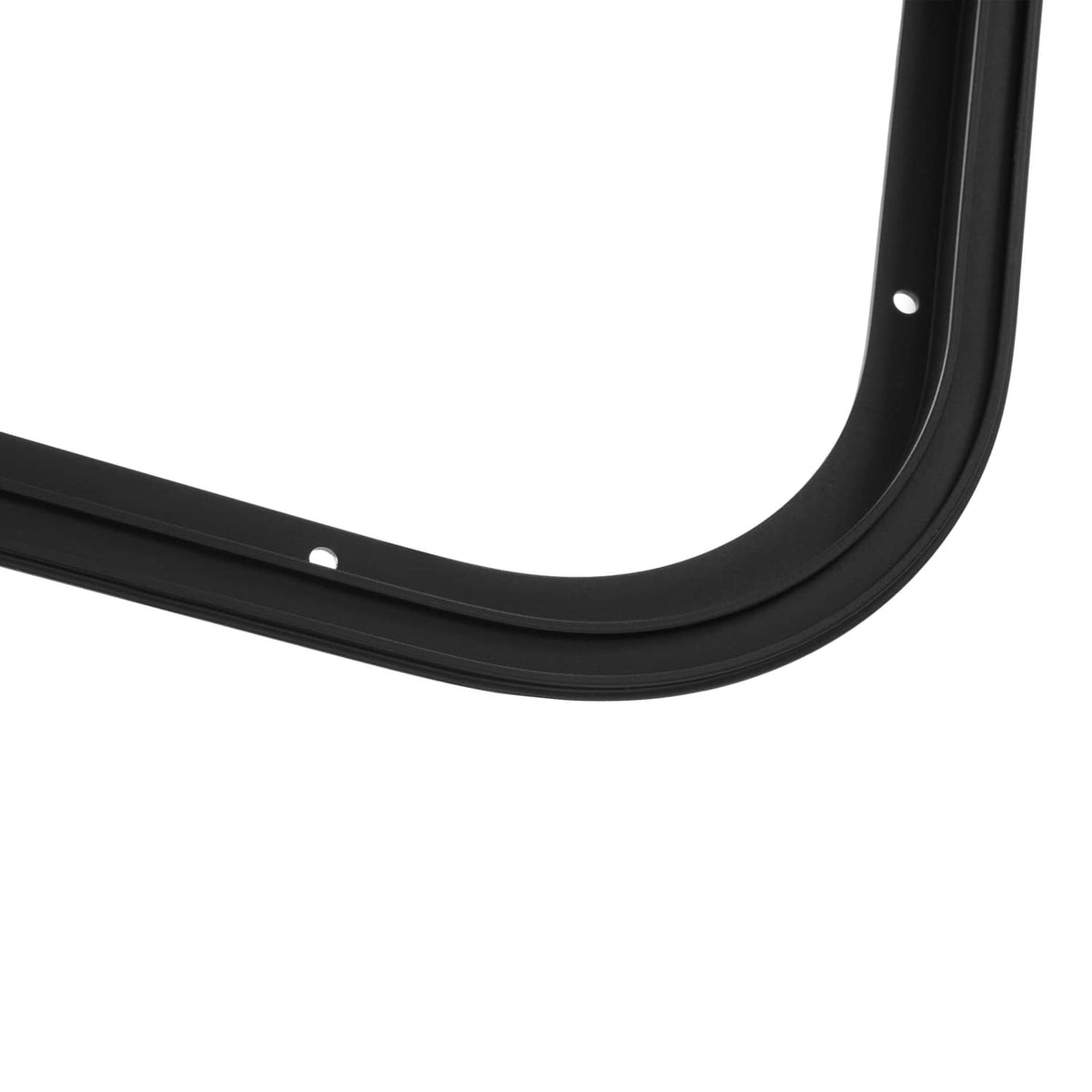 Dark RV window trim corner with curved edge and mounting hole detail.