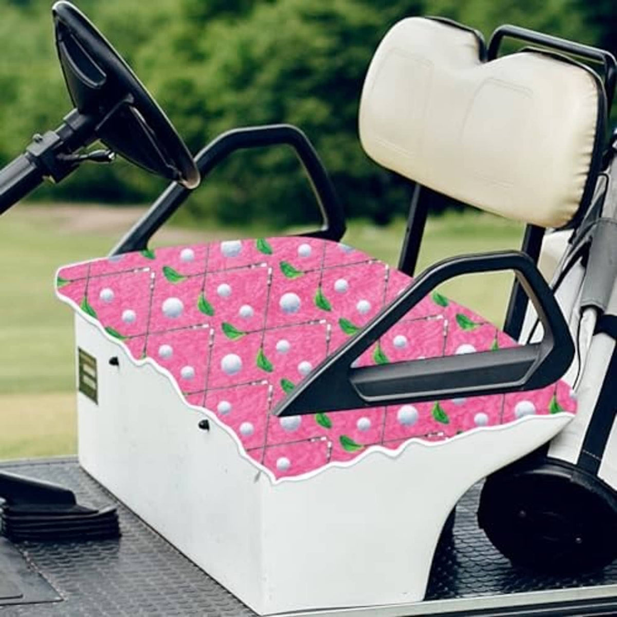 Golf cart seat cover in pink with leaf-and-dot pattern, scalloped edge detail