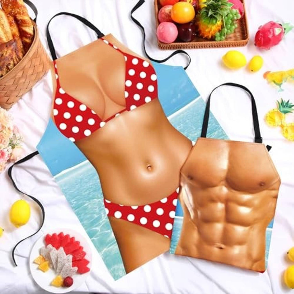 Two red polka-dot cooking aprons with black straps and front tie closure