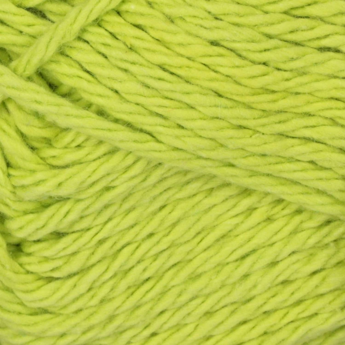 Light lime green cotton yarn close-up, twisted strands texture