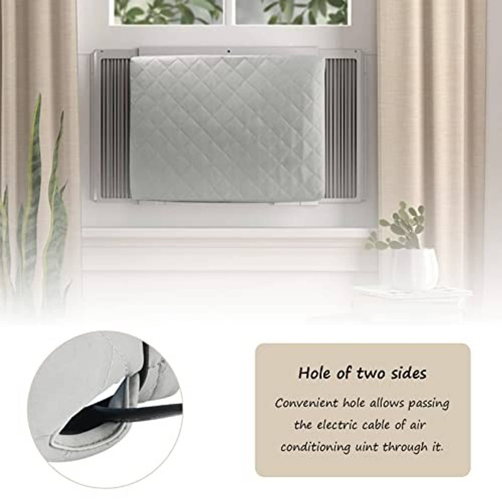 Grey quilted window AC cover installed inside a window with side vent panels.