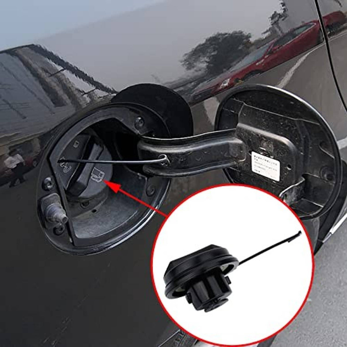 Black fuel tank filler cap assembly with tether shown in fuel door opening