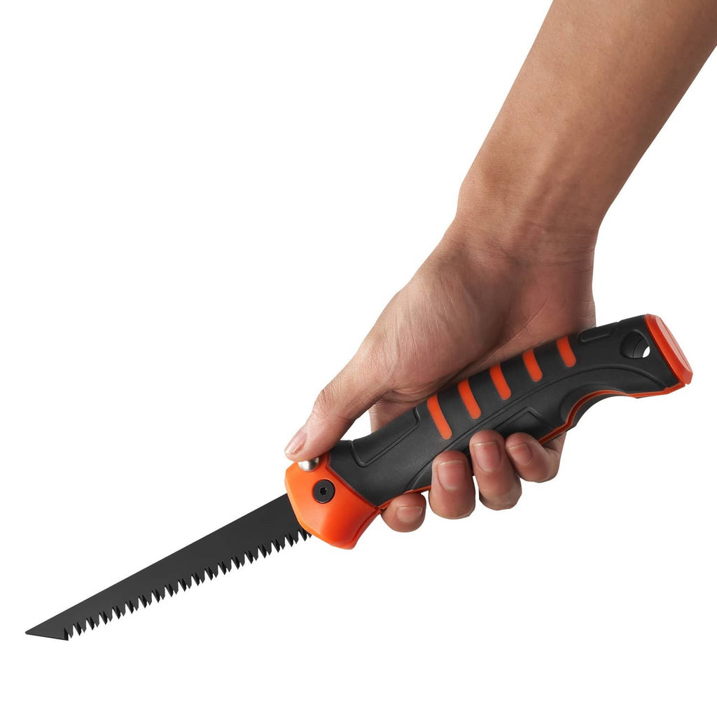 Hand-held folding saw with black and orange grip and serrated cutting blade