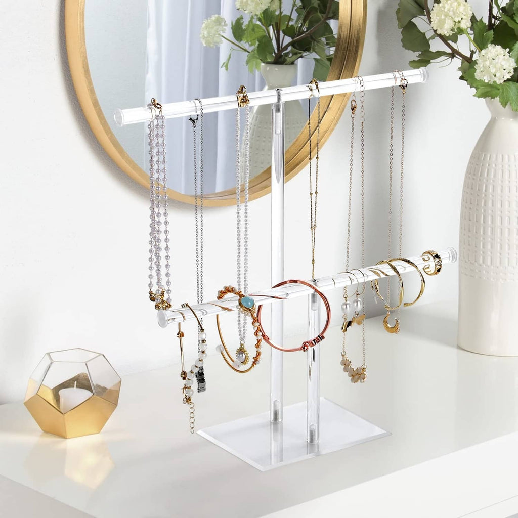 Clear acrylic necklace holder with tiered bars and dangling necklace hooks
