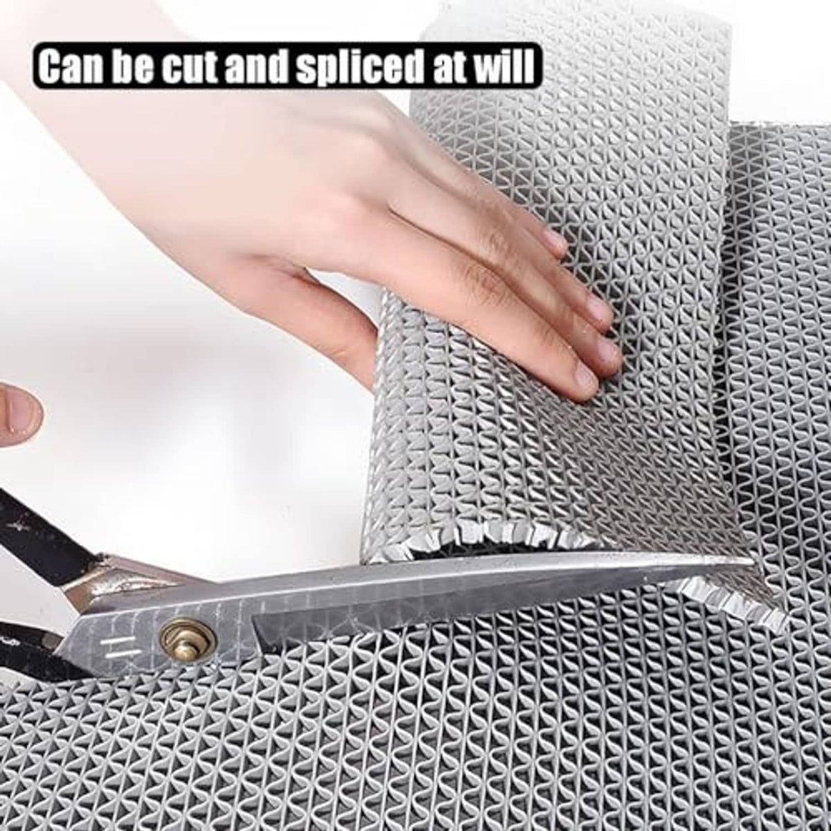Gray non-slip mat being cut with a utility knife on textured surface