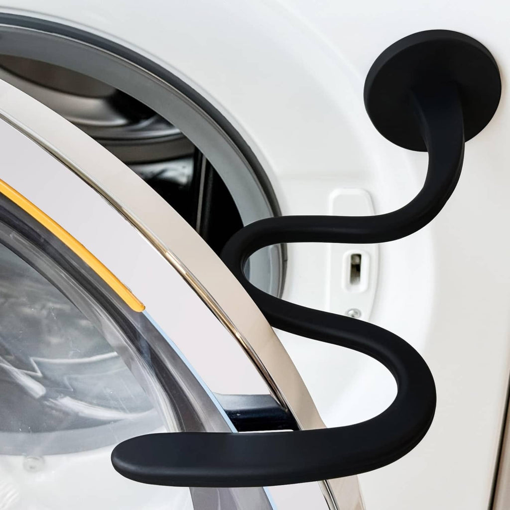 Black flexible washer door prop holding the open washer door