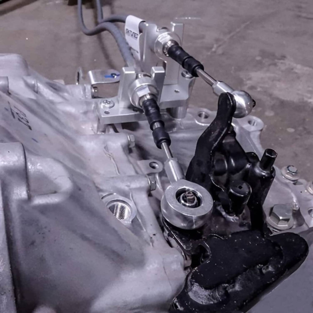 Mounted shifter cable linkage assembly with metal cables and pivot brackets