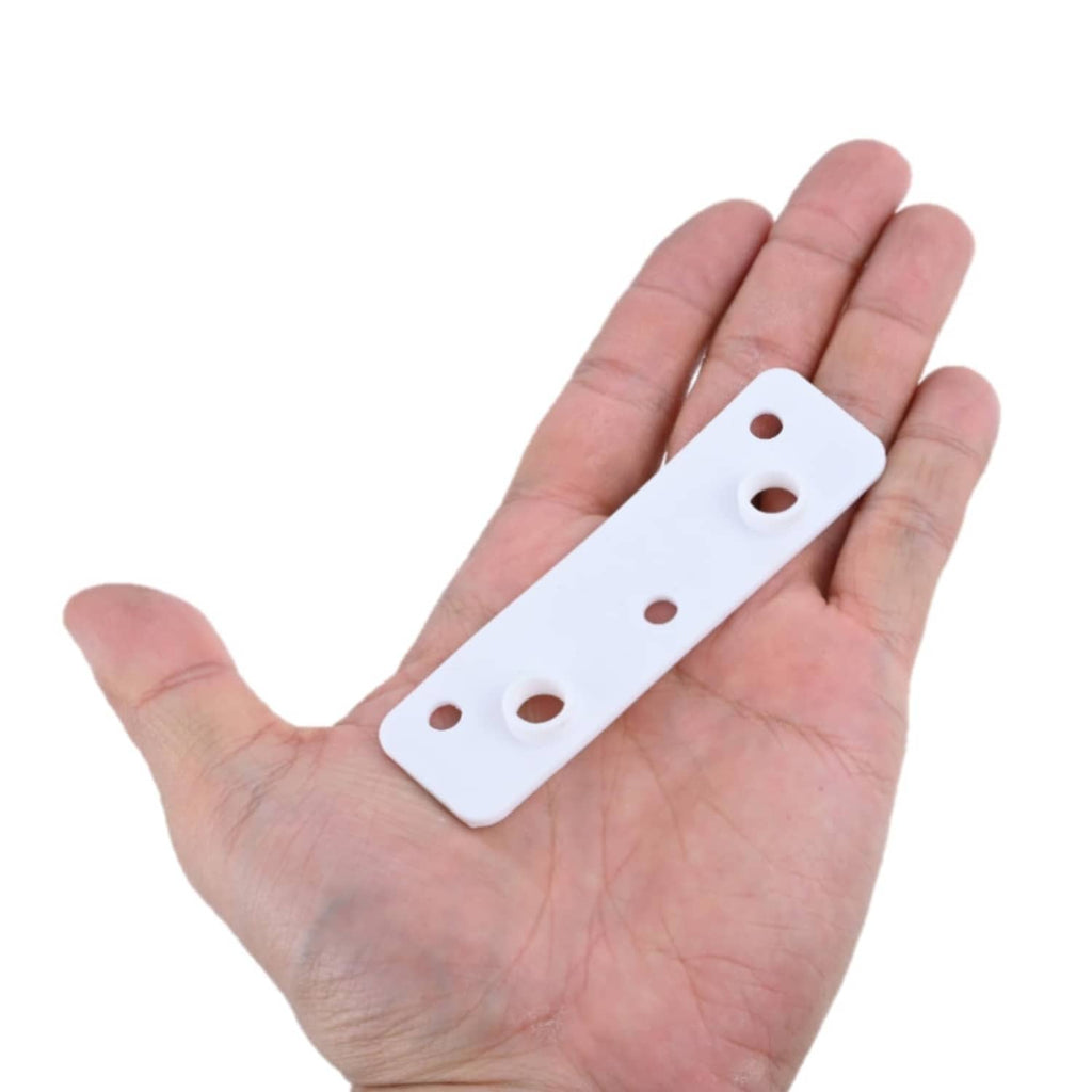 White mounting gasket plate with multiple screw holes held in a hand