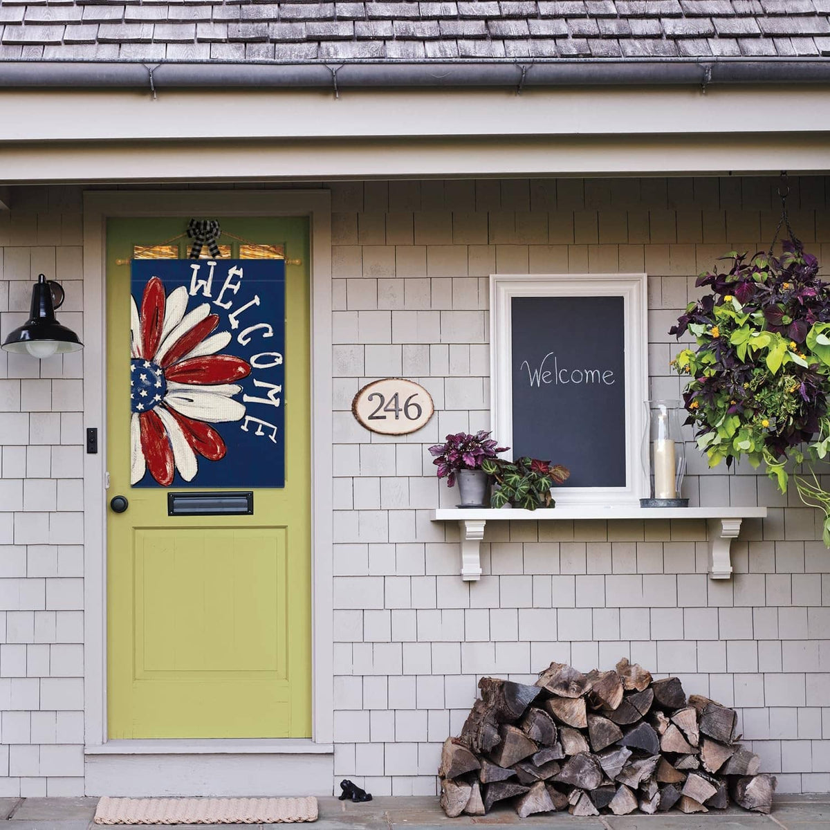 Patriotic house flag mounted indoors with red-white-blue flower and "WELCOME" letters