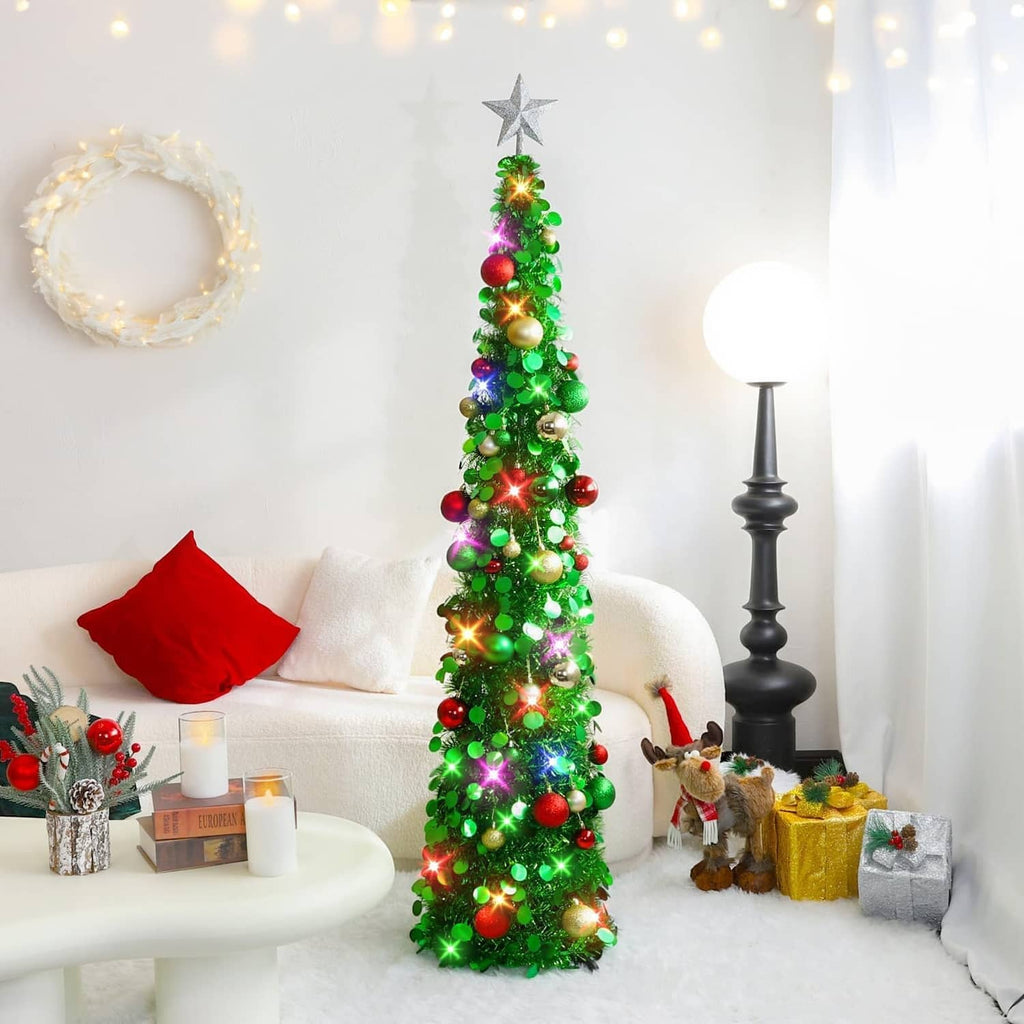 Lit green pop-up Christmas tree with silver star topper and multicolor baubles in room