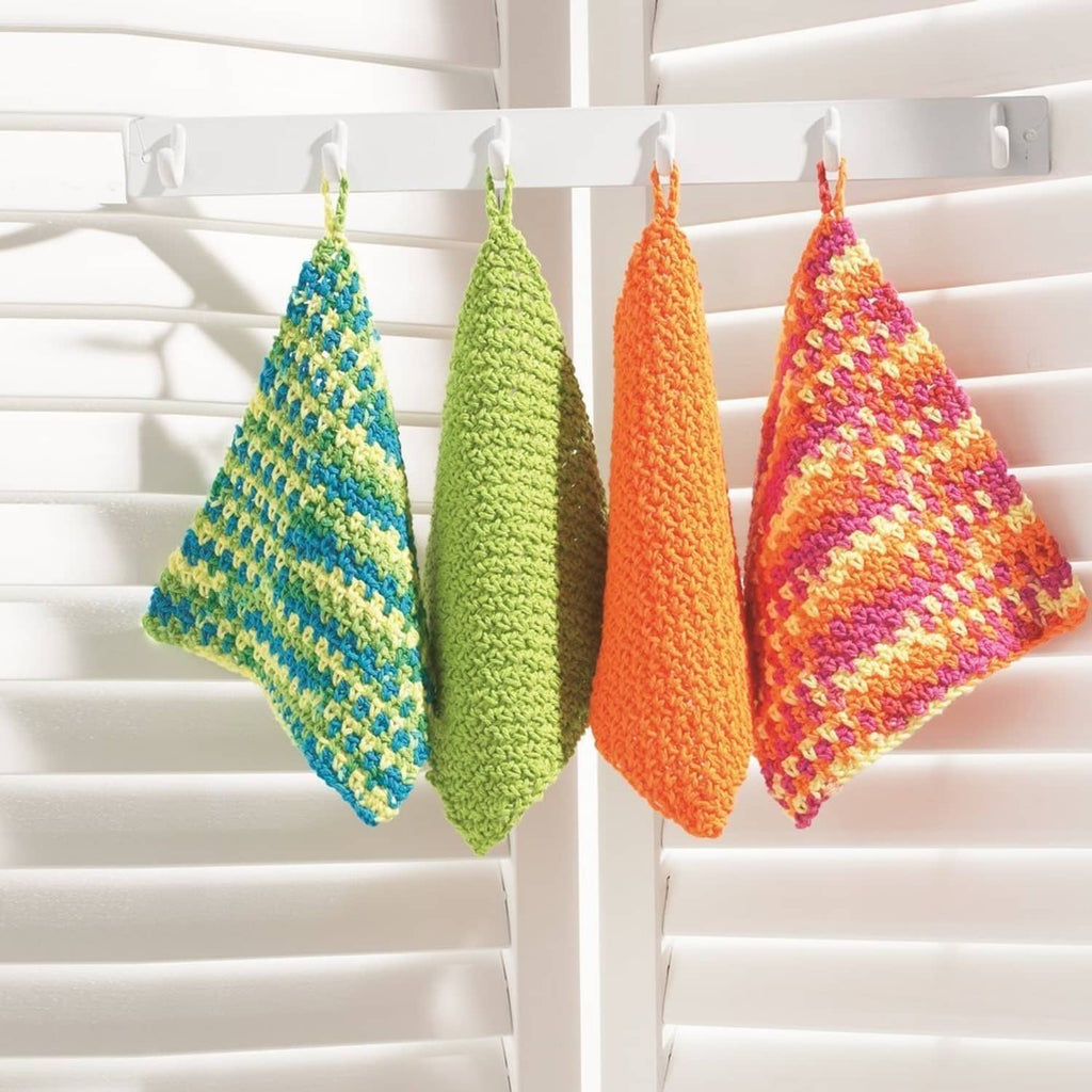 Set of hanging crocheted washcloths in green, orange, and pink stripes