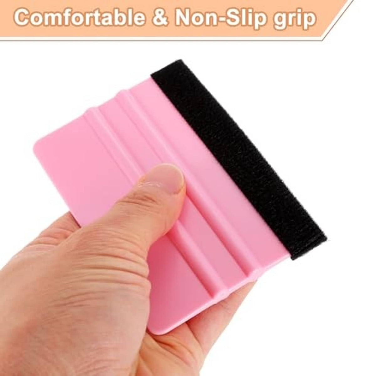 Hand holding pink vinyl squeegee with black felt edge and ribbed grip