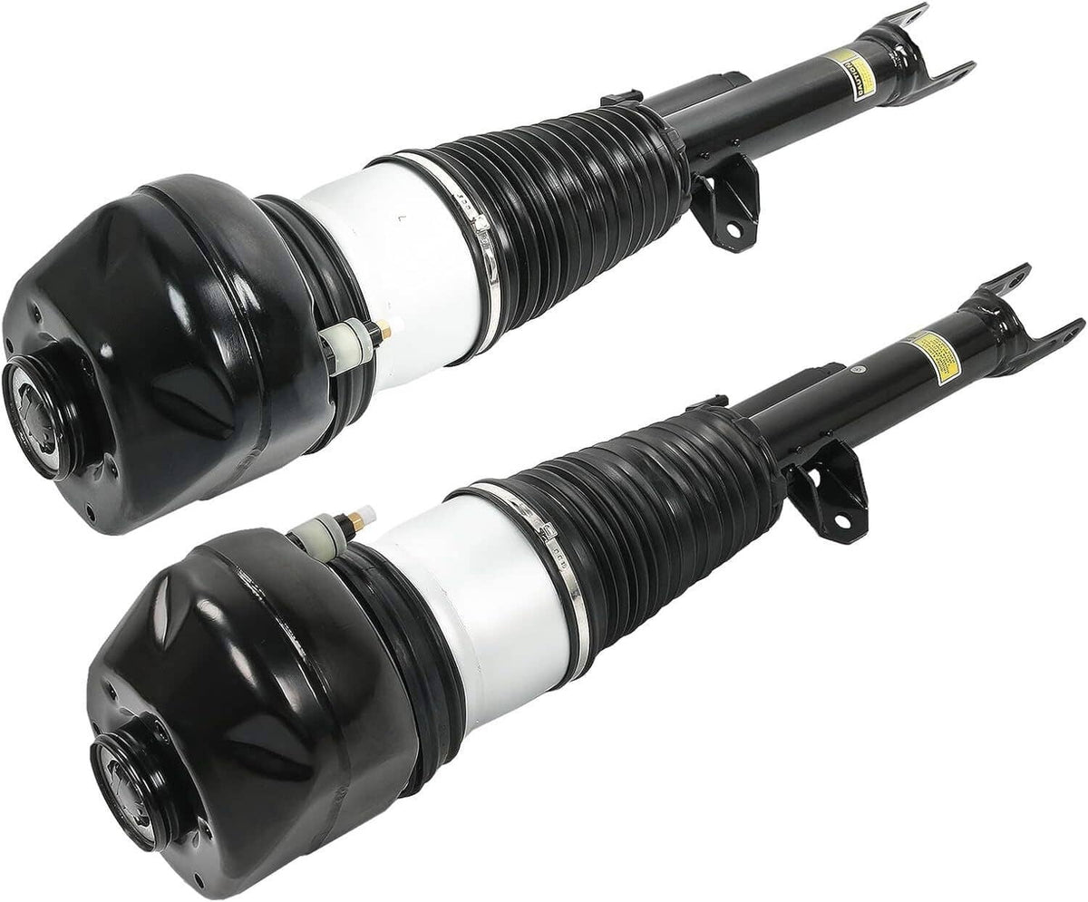 Front air suspension shock strut pair angled together, black springs with white cylinders