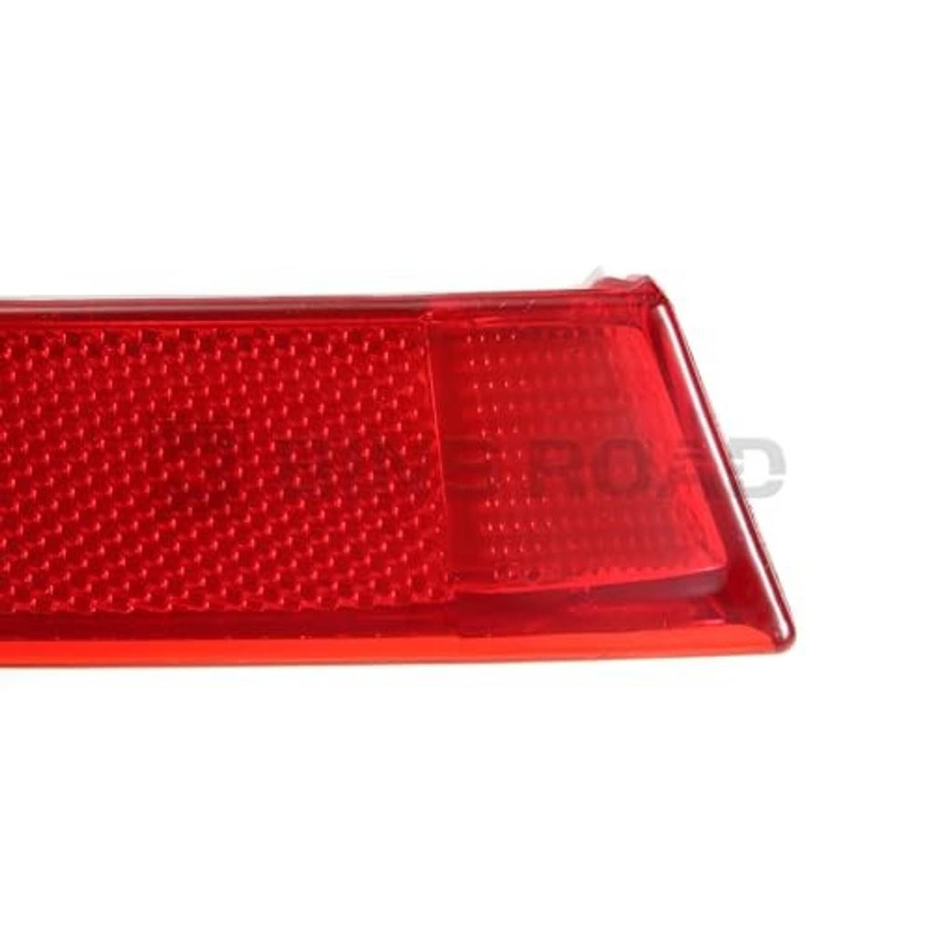 Red rear bumper reflector, textured lens with rectangular section and smooth frame.