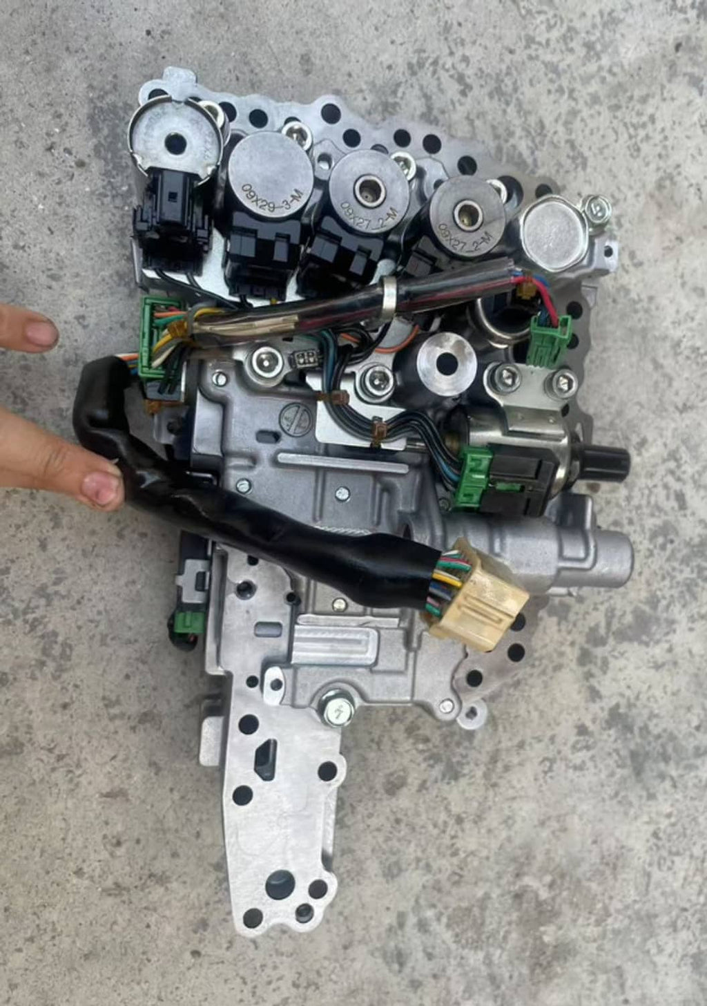 Auto transmission valve body with stepper motor, underside view with multiple connectors