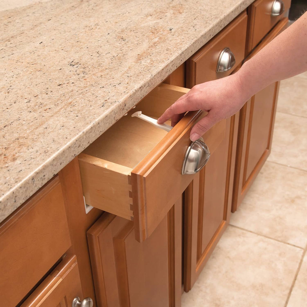 Babyproofing cabinet and drawer latch on a cabinet drawer, white lock mechanism