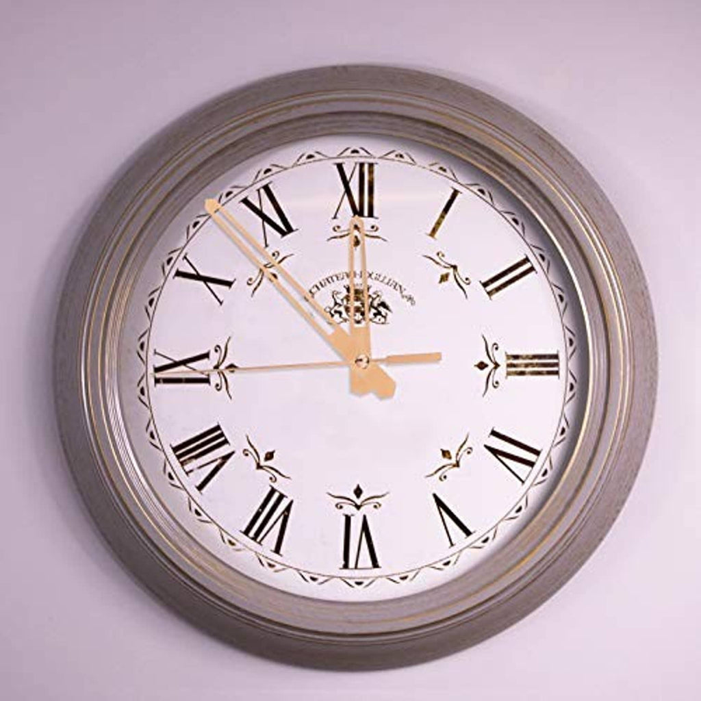 Round wall clock with Roman numeral dial, gold hands, and bronze outer frame